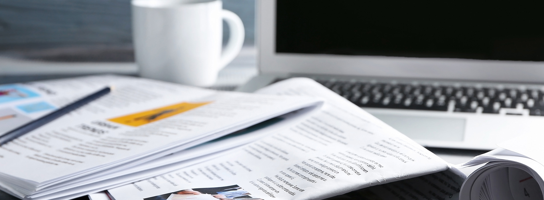 The image shows a cluttered desk with various items such as papers, a keyboard, a mouse, and a cup, suggesting an office environment.