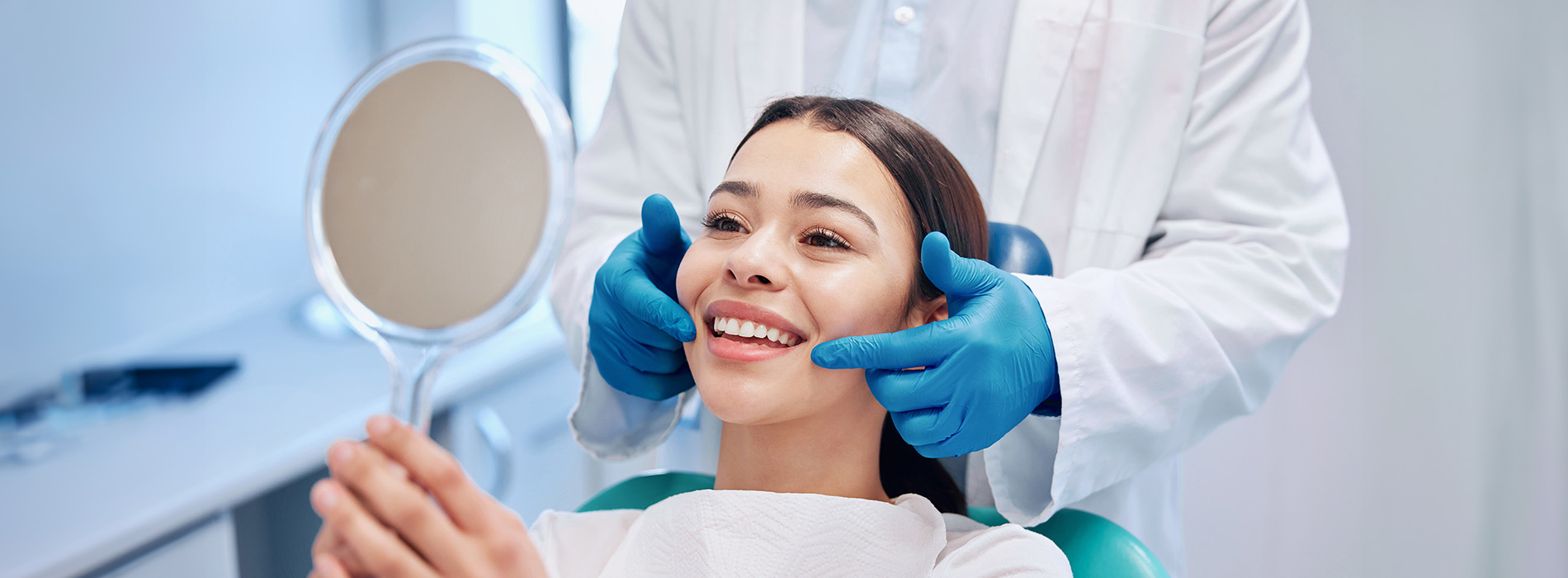 An image depicting a person receiving dental care with a dental hygienist using a mirror and tools.