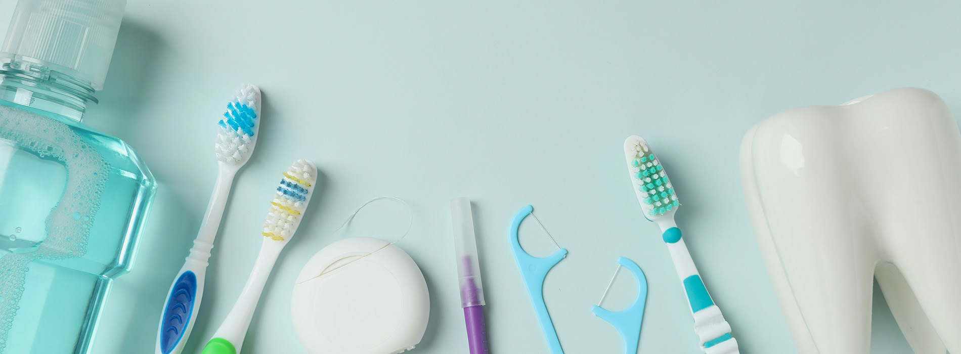 This is a composite image showing medical equipment and supplies, including a stethoscope, blood pressure cuff, tongue depressors, and other instruments, arranged in a manner that suggests they are part of a medical examination or procedure. The background is a solid color to emphasize the items.