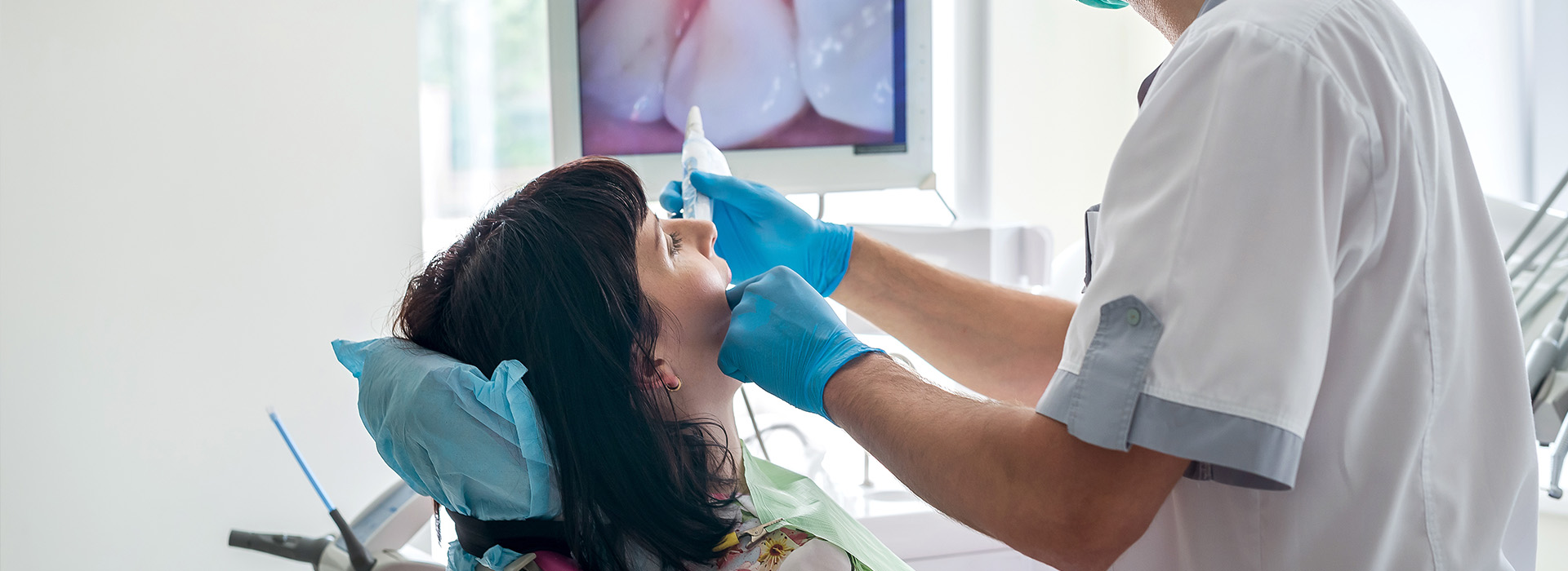 A medical professional performing dental work on a patient.